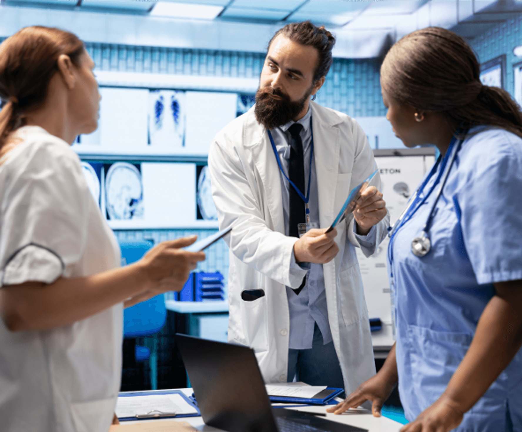 Healthcare team reviewing information on a tablet in a modern clinical setting