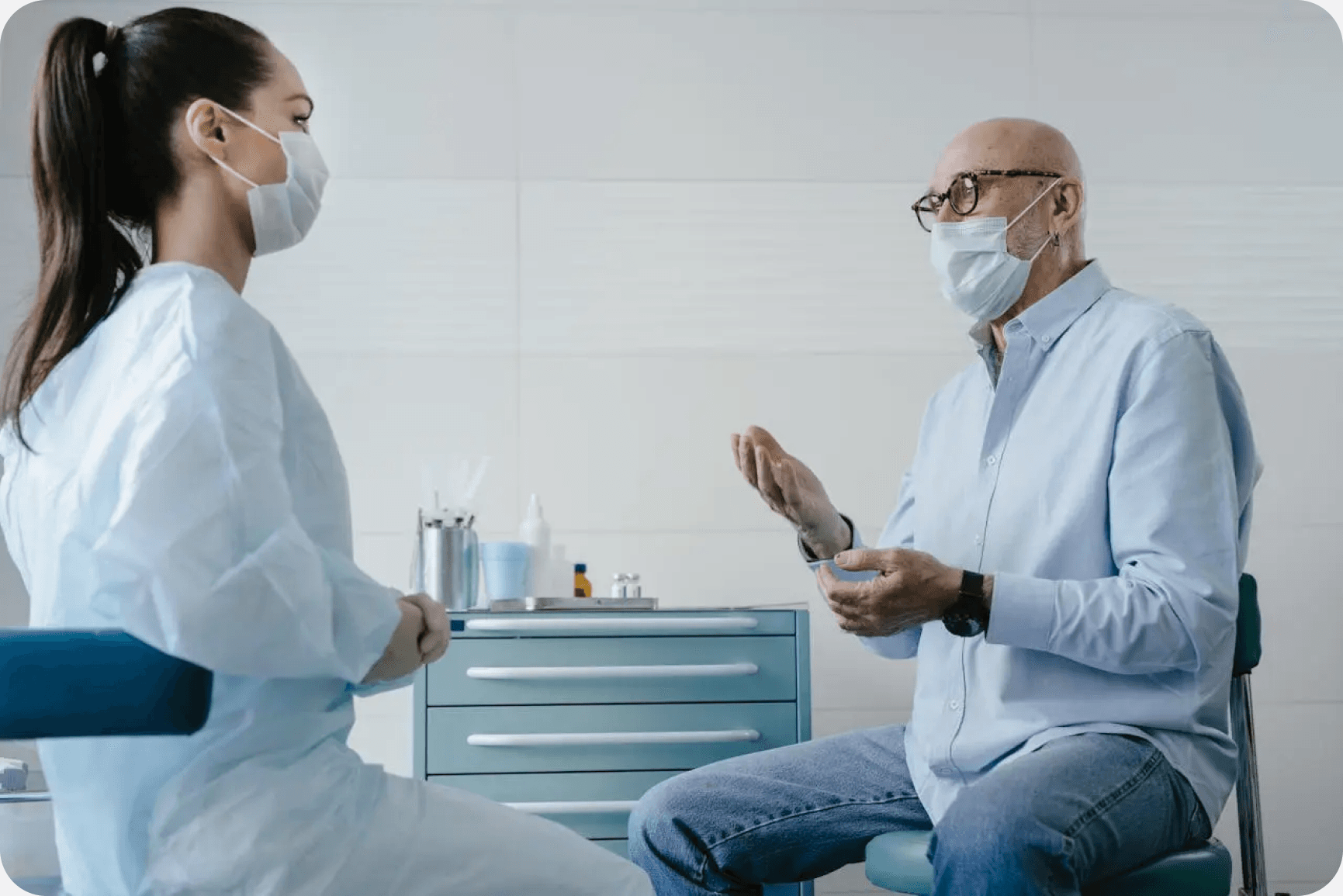 Healthcare professional speaking with a patient in a clinical setting