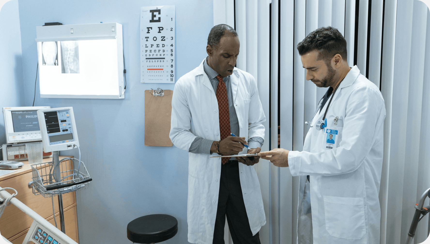 Two physicians reviewing clinical notes together in a hospital setting