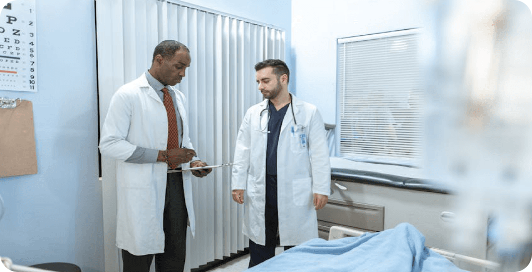 Two physicians discussing care in a clinical setting