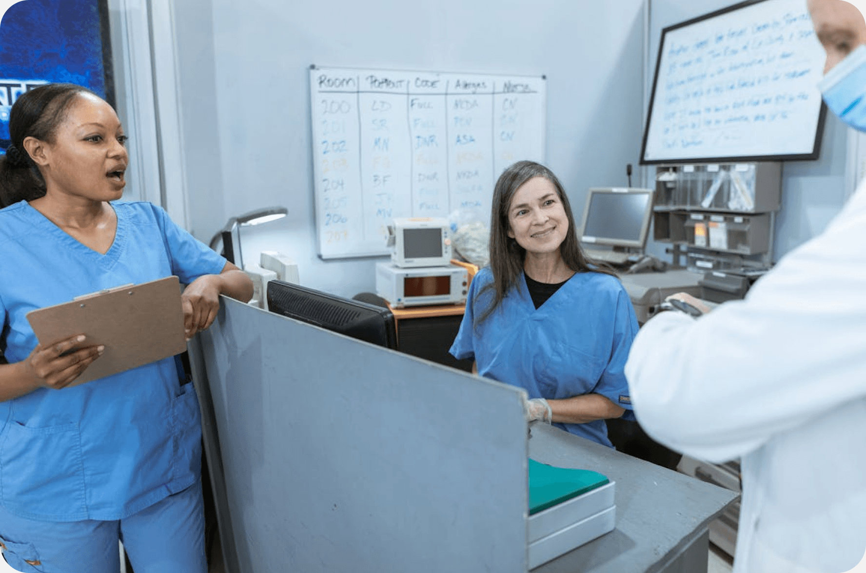 Medical staff coordinating credentialing at a nurses station with a tablet