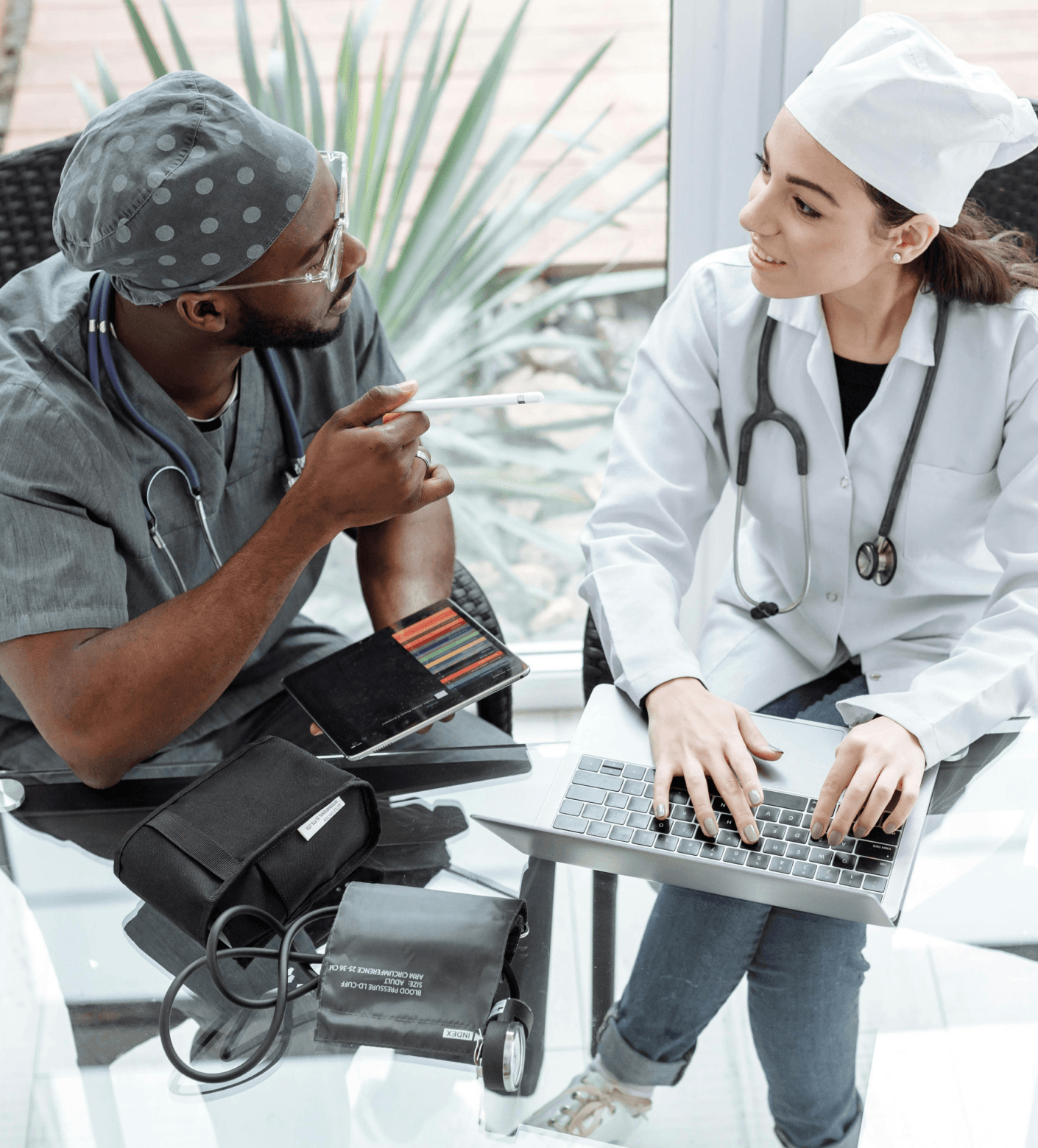 Clinicians collaborating over a tablet in a modern care setting