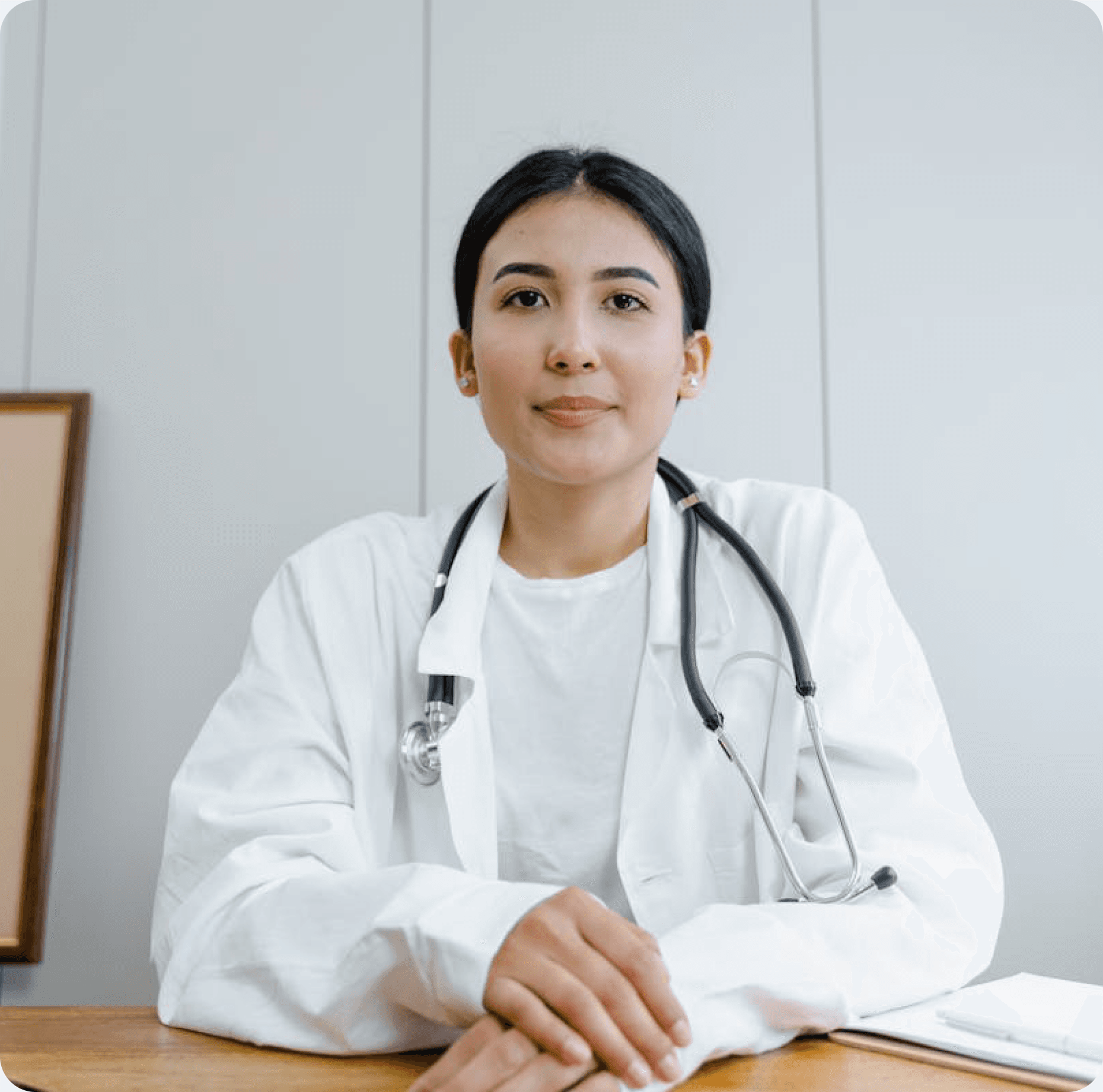 Physician in a white coat with stethoscope in a clinical setting