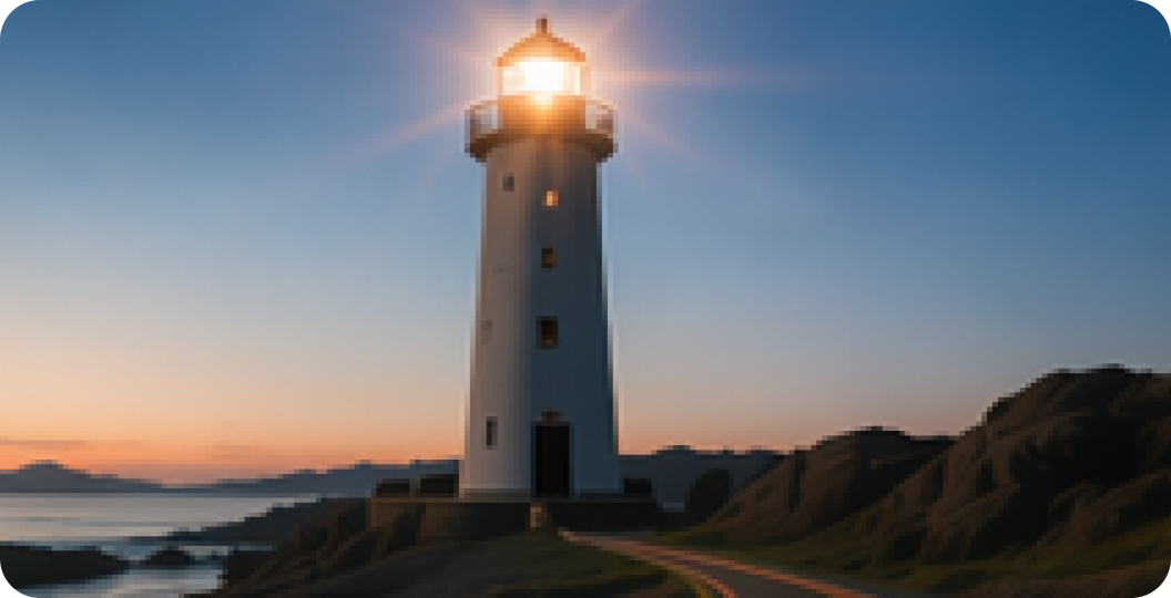Lighthouse on a rocky coast at dusk with its light glowing